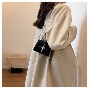 Minimalist black patent leather crossbody bag with silver star metal charm and chain