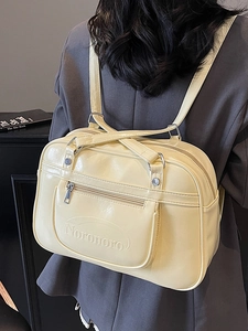 Vintage creamy yellow glossy leather backpack with embossed Noromoro logo detail