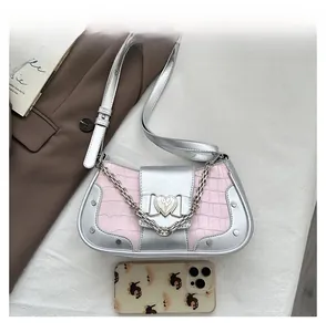 Detail view of pink stone pattern baguette bag with silver metallic trim and heart buckle