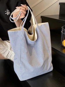 Blue and white striped canvas tote bag with large capacity and durable shoulder straps