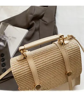 Detail of woven straw handbag featuring premium beige fiber texture and gold metal buckle