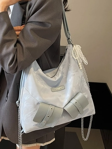Versatile light blue tote bag with artistic cloud print and silver chain straps