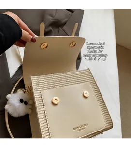Detail of cream structural bag with hidden magnetic buckles and woven leather texture