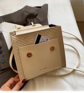 Detail shot of the cream woven leather crossbody bag with a functional front card pocket