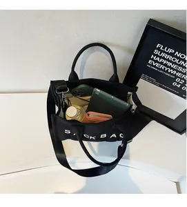 Interior view showing the large capacity of the black canvas tote bag for daily essentials