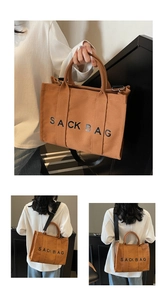 Detail of caramel canvas sack bag showing dual handles and adjustable nylon strap