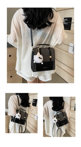 Detailed back view of a checkerboard pattern handbag with a white fluffy pompom charm