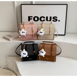 Detailed display of square woven backpacks in pink, white, black, and brown leather trim