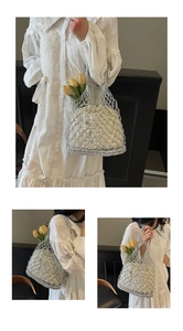 Detail view of silver woven mesh tote bag with a white drawstring liner for beach vacations