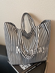Minimalist black and white striped canvas tote bag with Monday slogan for daily commute
