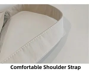 Close-up of a wide comfortable shoulder strap on a canvas tote bag with reinforced stitching