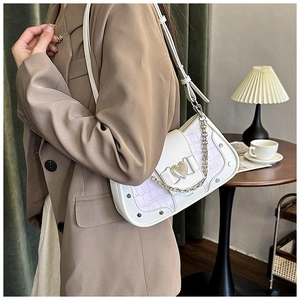 Detail of white and lilac faux crocodile underarm bag featuring a heart-shaped metal lock