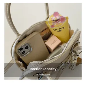 Macro view of the cream shell bag interior showing storage space for phone and makeup
