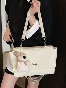 Minimalist cream white briefcase bag with silver buckle and plush bear pendant detail