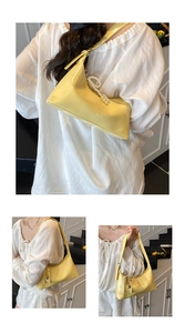 Détail du sac hobo en cuir souple jaune avec pendentif perle et nœud décoratif