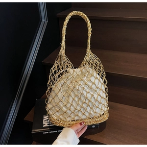Detail of gold woven mesh handbag featuring a white drawstring liner and rope handle