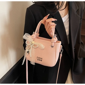 Pink lychee texture bucket bag with lace bow, pearl chain and silver heart charm detail