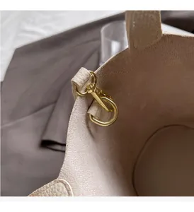 Detail of the high-shine gold swivel clasp and pebbled leather interior of the tote bag