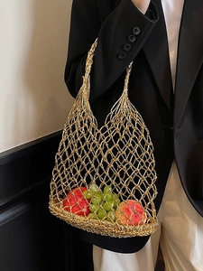Golden woven mesh tote bag with cutout design for beach vacation and casual style