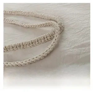 Close-up of woven cotton shoulder straps and detailed knit texture of the white beach bag