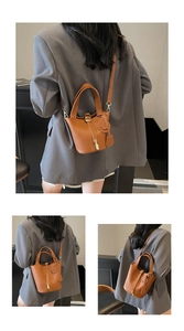 Detail view of brown lychee grain PU bucket bag with adjustable strap and metal lock