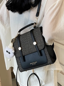 Retro contrast color tweed crossbody bag with gold hardware and plush charm on white shirt