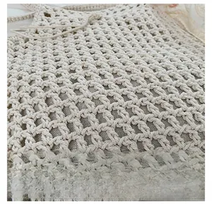 Detailed close-up showing the intricate honeycomb woven texture of the beige beach bag