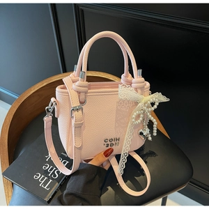 Pink lychee texture bucket bag with pearl bow charm and silver metallic lettering