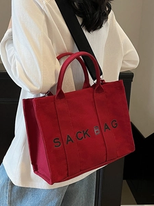 Versatile red canvas tote bag with black SACK BAG print for commute and travel