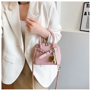 Detail view of pink shell-shaped tote bag with lychee grain PU leather and silk scarf