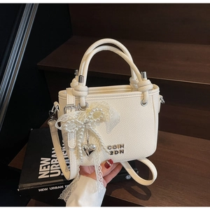 White litchi pattern bucket bag with pearl bow charm and silver logo detail