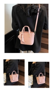 Detailed close-up of pink lychee-patterned PU leather bucket bag with silk scarf handle