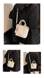 Detail view of cream bucket bag with lychee texture leather and decorative floral silk scarf