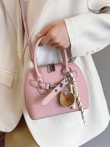 Pink lychee texture shell bag with silver hardware and decorative bag charms