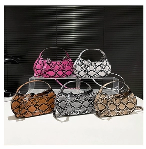 Detail of snake print crescent baguette bags with adjustable straps in five colors