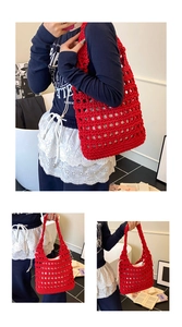 Detail of red hollow crochet tote bag showing wide woven handle and large mesh knit texture