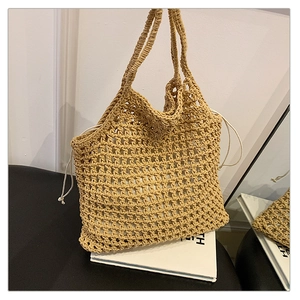 Close-up of khaki handmade woven beach bag showing mesh texture and white drawstring lining
