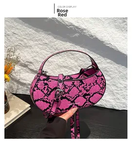 Macro shot of rose red snakeskin texture handbag with a semi-circle shape design