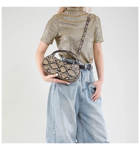 Detail of trendy python print half-moon handbag with adjustable crossbody strap