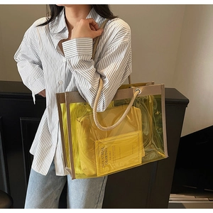 Detail view of yellow transparent PVC tote bag with rope handle and inner zipper pouch