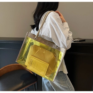 Detailed shot of transparent yellow PVC tote bag with rope handle and matching inner pouch