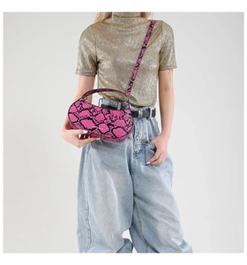 Pink snake-print leather crescent moon bag styled with golden glitter top and denim