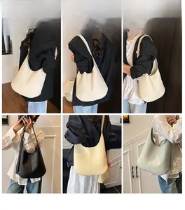 Multiple colors of large lychee texture tote bags shown on a model for daily styling