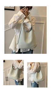 Detail view of large mint green lychee pattern leather tote bag with soft strap