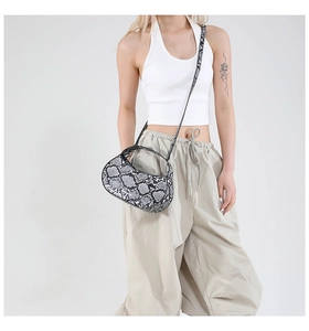 Chic grey snakeskin underarm baguette bag shown with a minimalist fashion outfit style