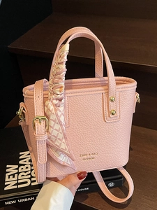 Pink lychee grain faux leather bucket bag with silk scarf handle and gold logo