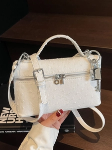 White ostrich texture rectangular handbag with silver lock and adjustable shoulder strap