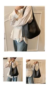 Detail view of black lychee grain leather tote bag with elegant teardrop shape and wide strap