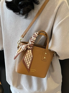 Chic brown litchi pattern bucket bag with decorative silk scarf handle and leather strap