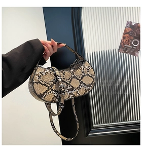 Detailed view of the python pattern handbag showing texture and silver metal hardware